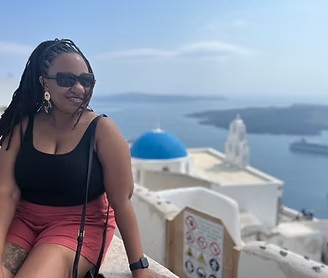 Brittney Lee smiling above the caldera in Santorini